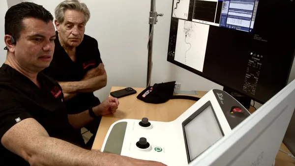 Neurosurgeon Vitor Mendes Pereira, left, with XCath Chairman Fred Moll, co-founder of Intuitive Surgical.