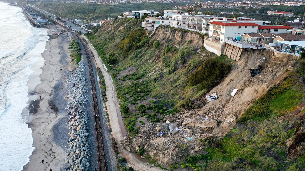 An aerial view of a hillside landslide brought on by heavy rains, which caused four ocean view apartment buildings to be evacuated and shuttered due to unstable conditions, on March 16, 2023 in San C