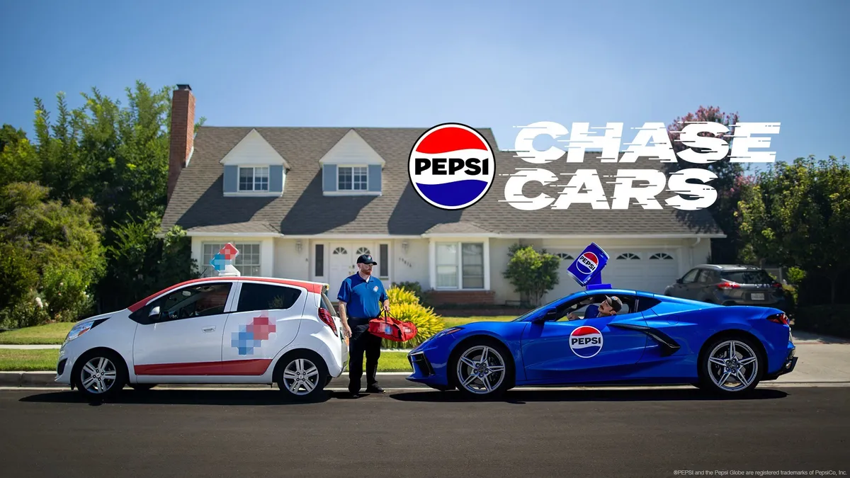 Two food delivery cars and their drivers parked outside of a suburban home