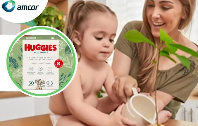 A Huggies diaper box next to an adult with a baby.