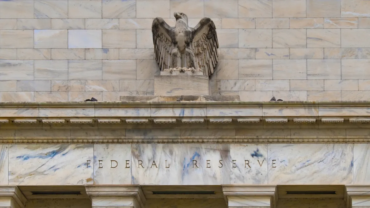 The words Federal Reserve engraved in a marble building with an eagle above.