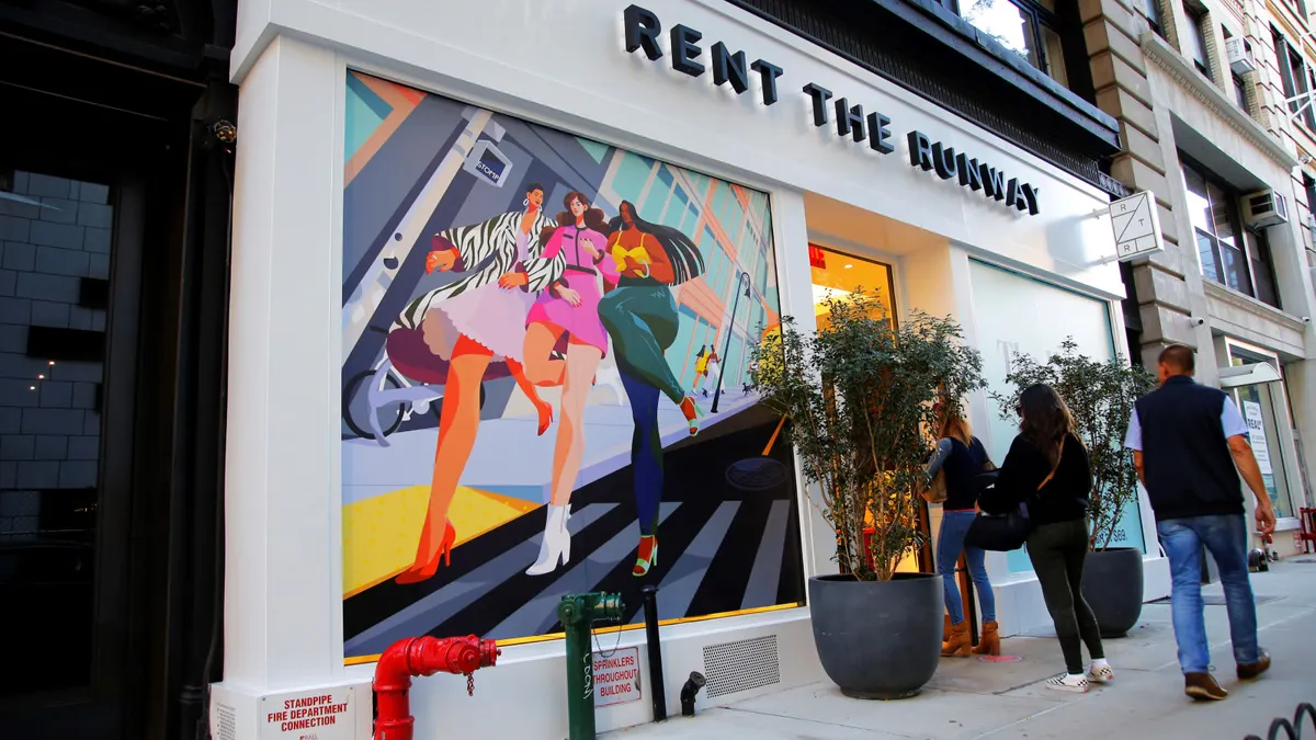 People pass by a Rent the Runway store.