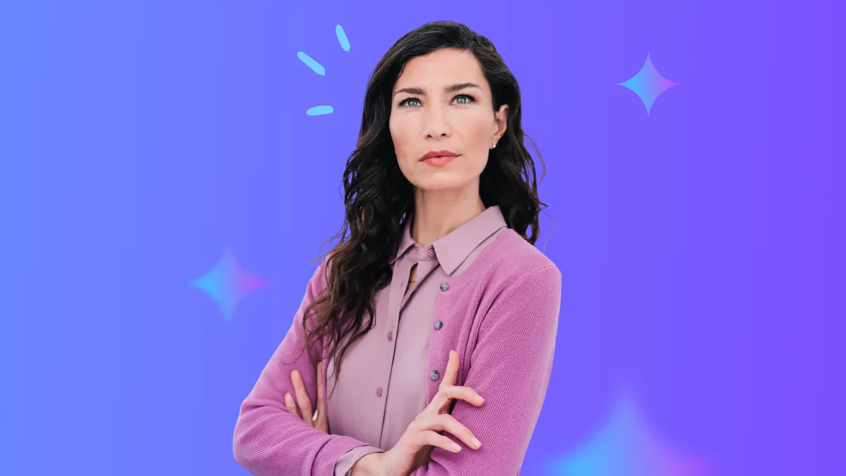 middle aged woman with dark hair and pink sweater