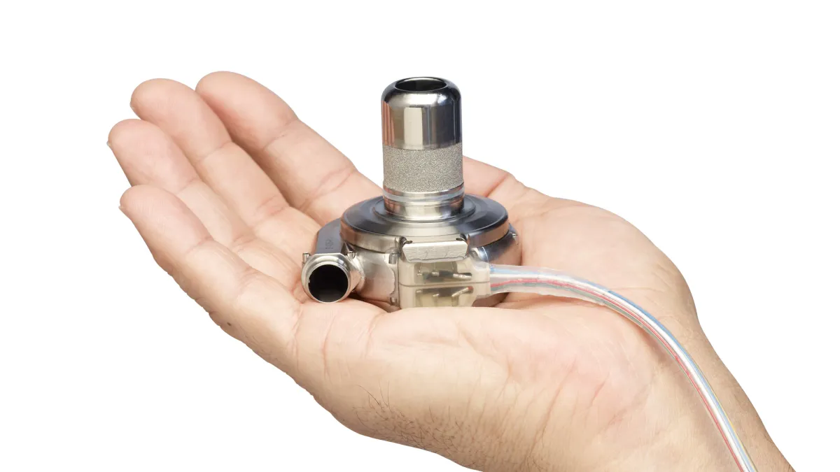 A Medtronic HVAD pump in the palm of a human hand