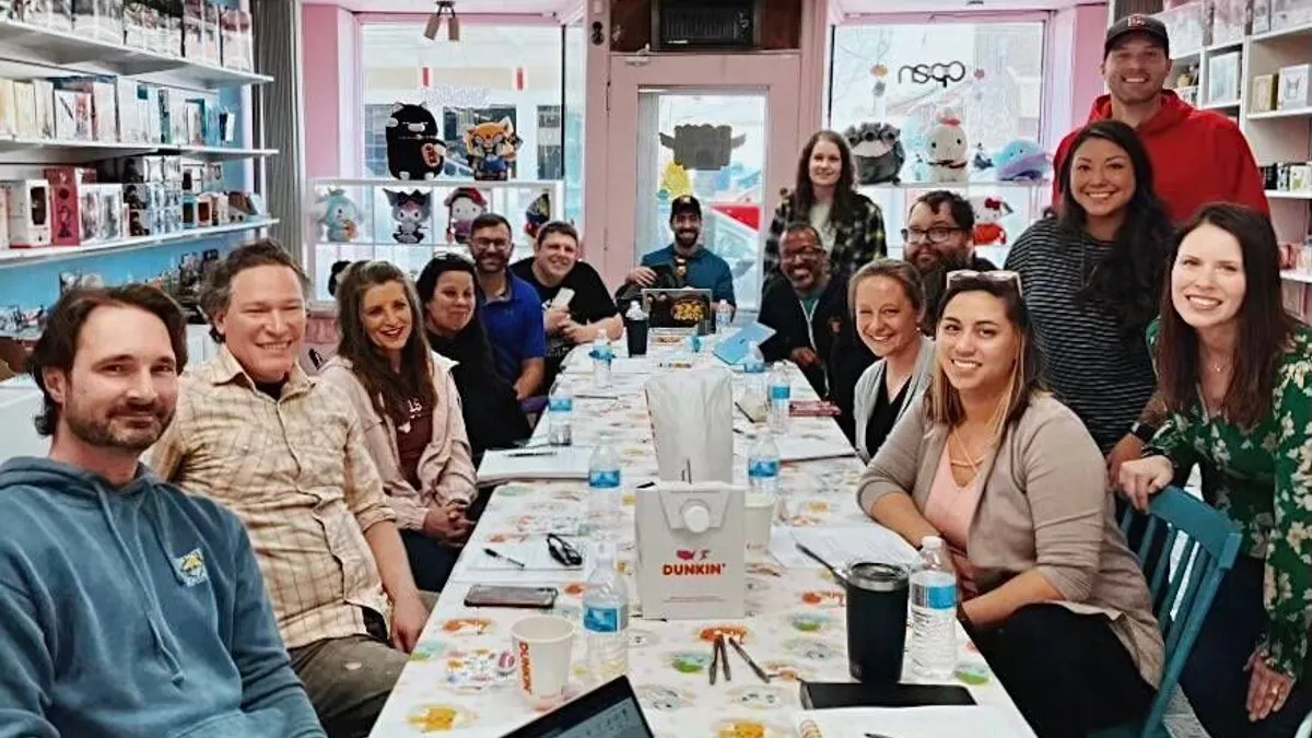 A group of former Hyland coworkers pose in Doki Doki Kawaii Shop, a hobby shop in Lakewood, Ohio.