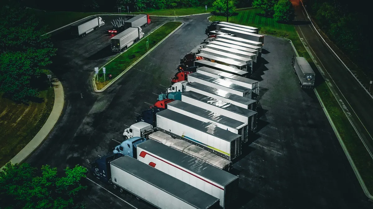 Trucks parked in a parking area at night.