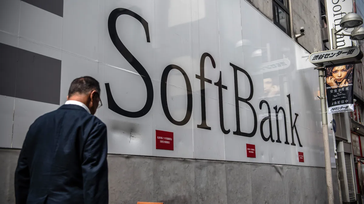 Man walks past Softbank mobile store