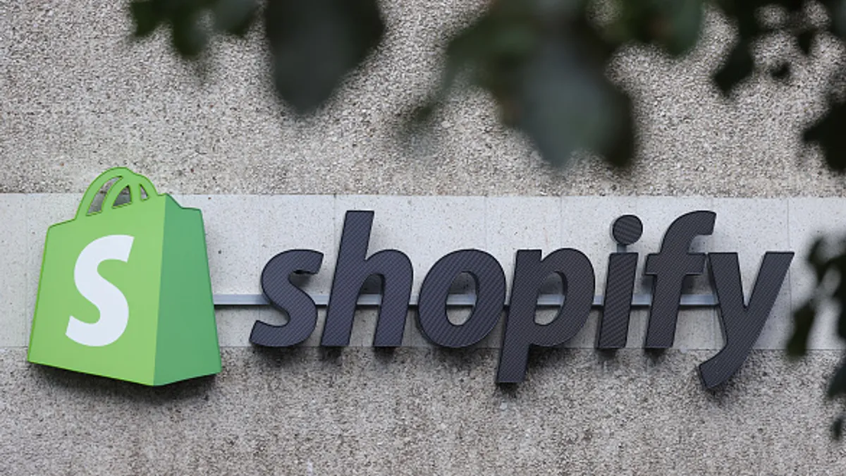 The corporate logo of e-commerce company Shopify hangs at the building that contains the offices of Shopify Commerce Germany GmbH on August 08, 2022 in Berlin, Germany.