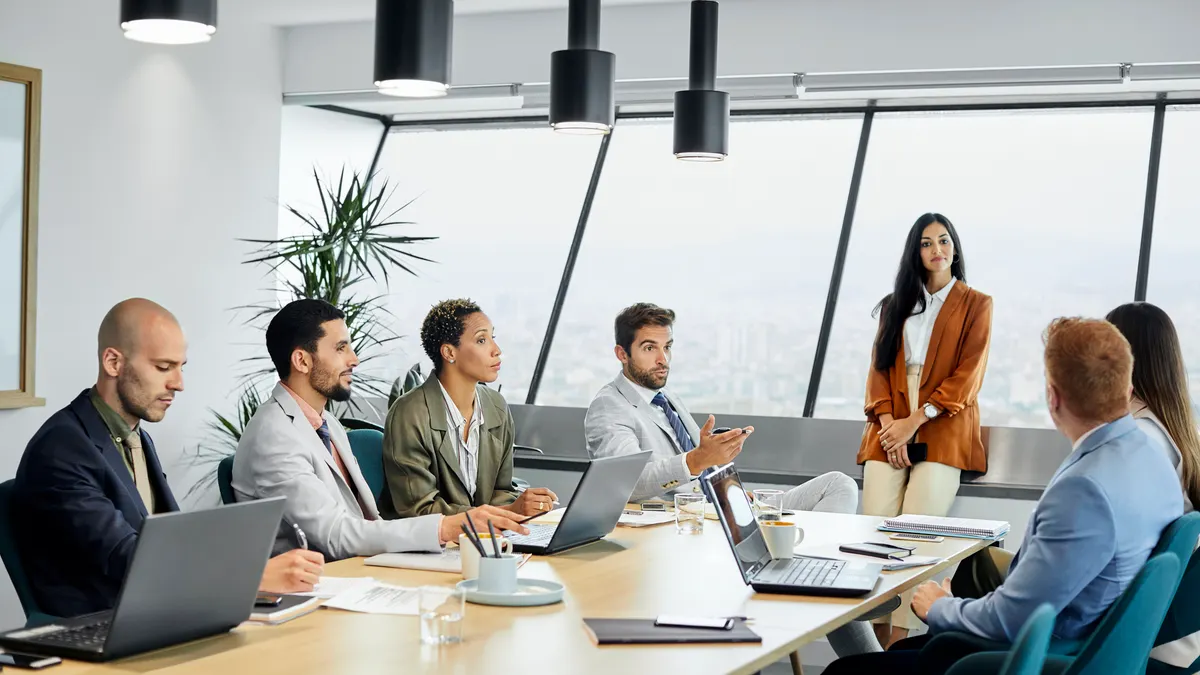 Professionals brainstorming in board room.