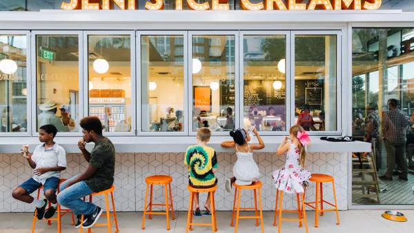 Children and consumers eat ice cream outside a Jeni's Splendid Ice Creams location.