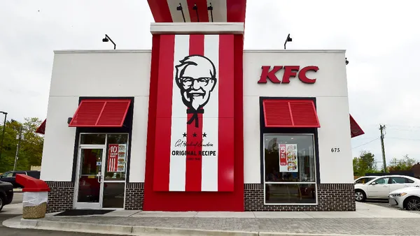 An image of a white building with red stripes and KFC branding.