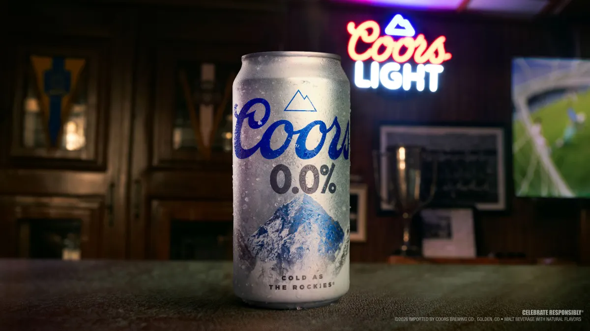 A can of Coors 0.0% is on a bar.