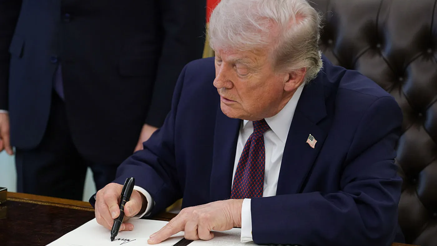 President Donald Trump signs an executive order
