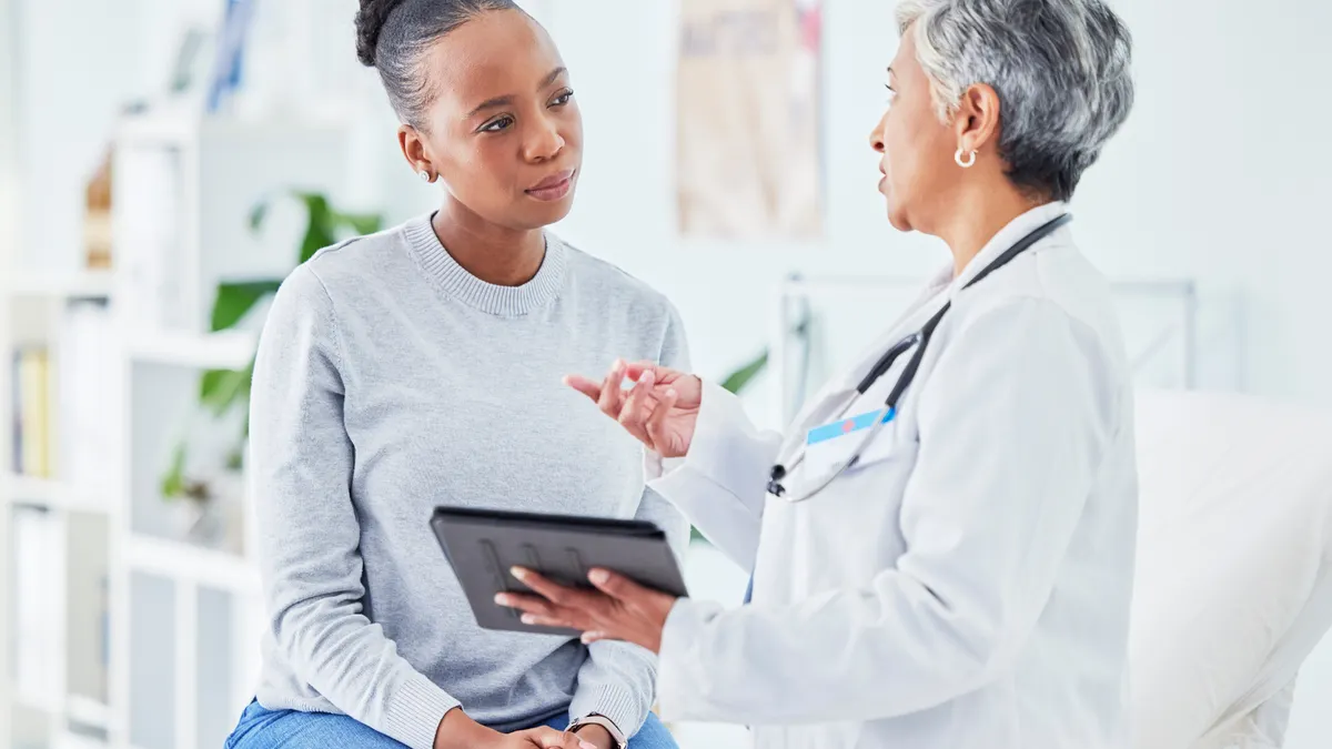 Doctor, woman and tablet for hospital, healthcare advice and support for results, exam and test on bed. Senior expert or medical people on digital tech for clinic sign up, registration and consulting.