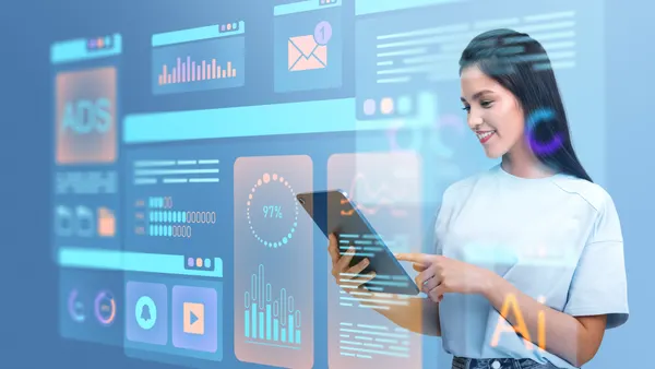 Woman using a tablet with holographic virtual data interfaces