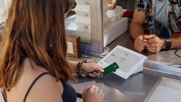 A customer pays using a Clover device