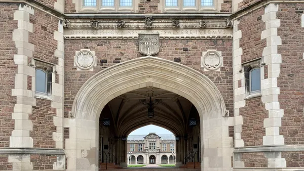 Entryway in gothic style building. Through it, we see another building farther away.