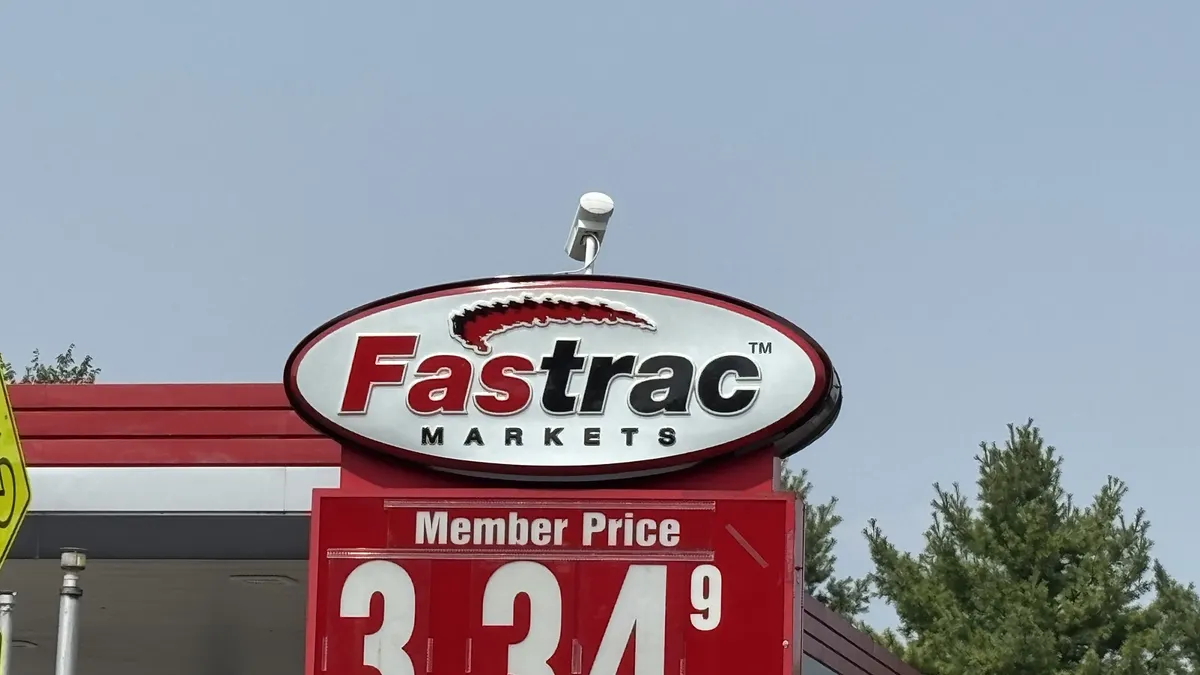 A sign outside a gas station. The sign says "Fastrac."