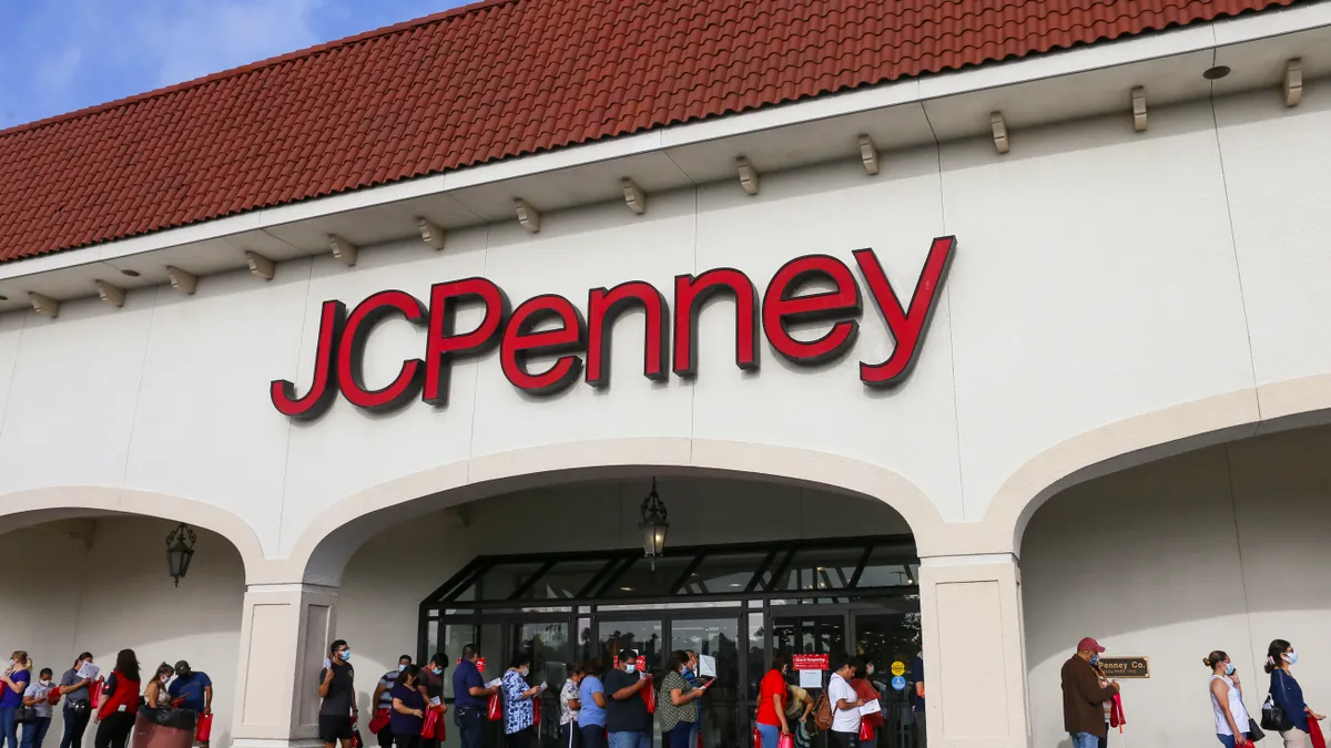 A white JC Penney store with a red roof.