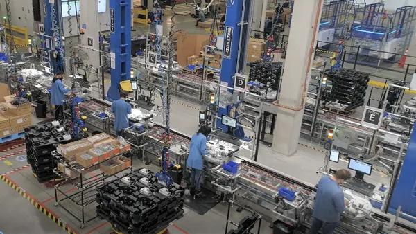 Workers operate Amazon's robotics manufacturing line in Massachusetts.
