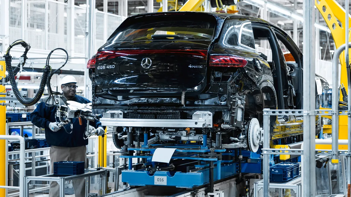 A worker assembles a vehicle at Mercedes-Benz's factory in Alabama