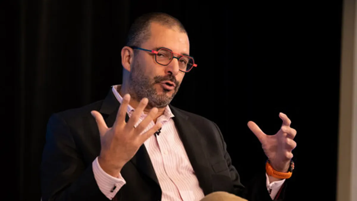 Pascal Belaud gestures with his hands while he speaks.