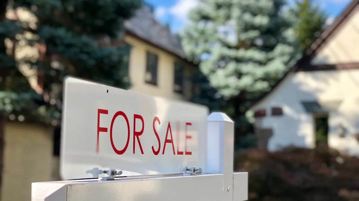 Real estate for sale sign in residential neighborhood, New Jersey, USA.