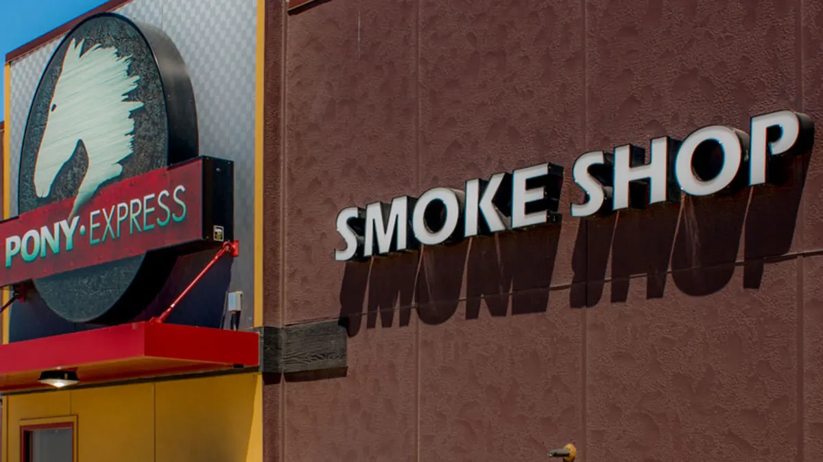 A photo of the exterior of a building. Signs say Pony Express and Smoke Shop.