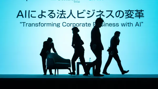 Silhouettes move a stage set against a pale teal background. The sign reads "Transforming Corporate Business with AI" in both English and Japanese.