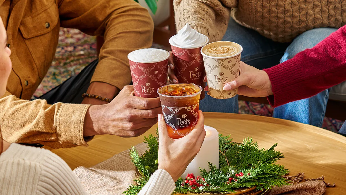 Individuals holding Peet's Coffee seasonal drinks