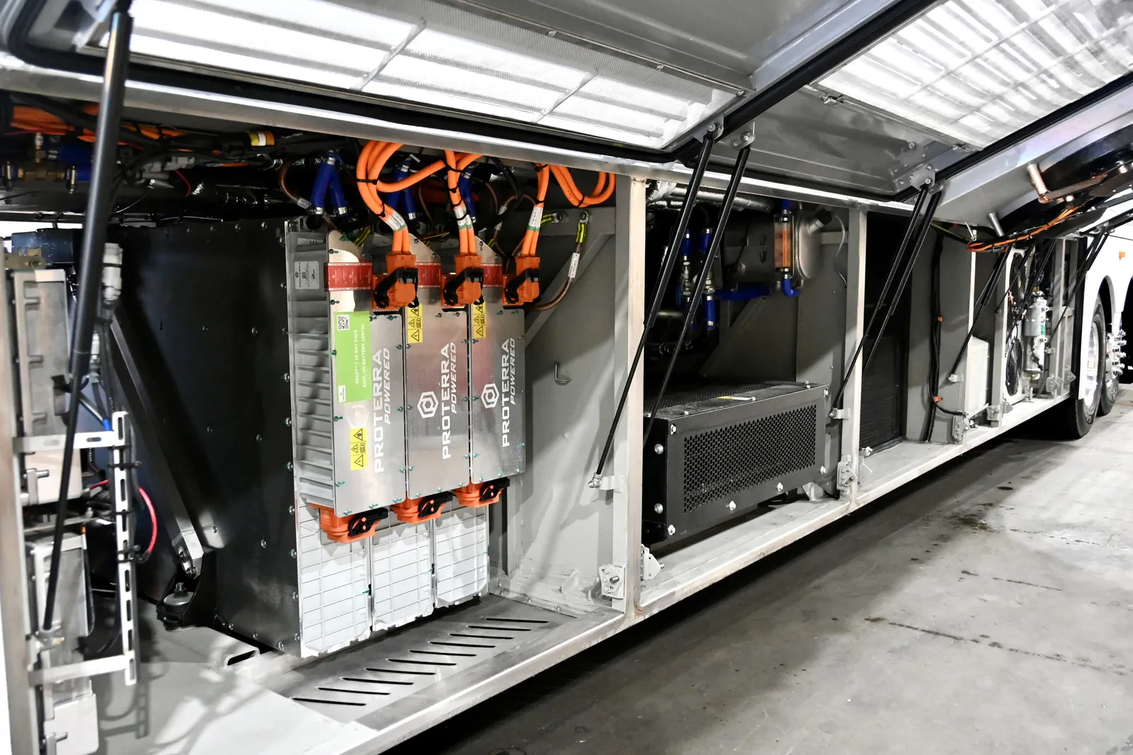 Electric bus batteries mounted in luggage compartment.