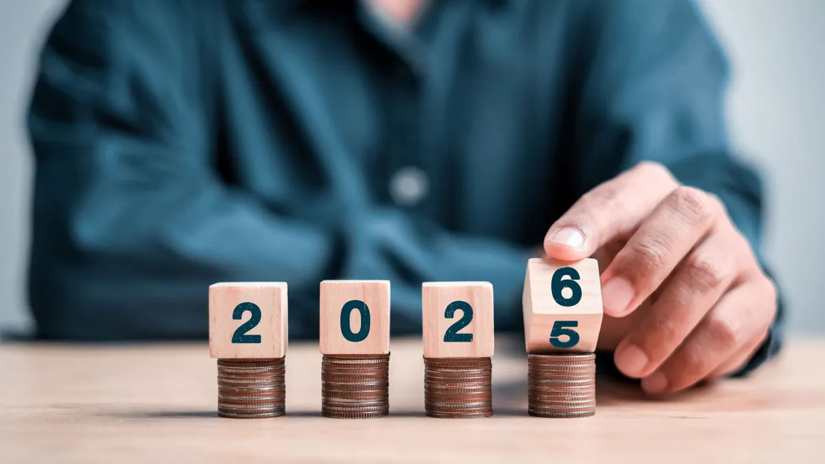 Four stacks of quarters, each with a number block to show 2026.