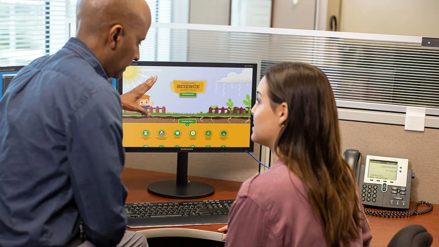 Man explaining to women using monitor