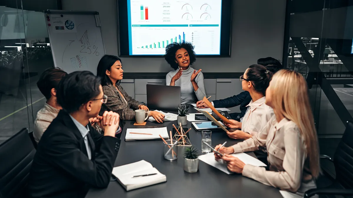 Group of senior members at an enterprise discussing technology strategy and aligning business priorities.