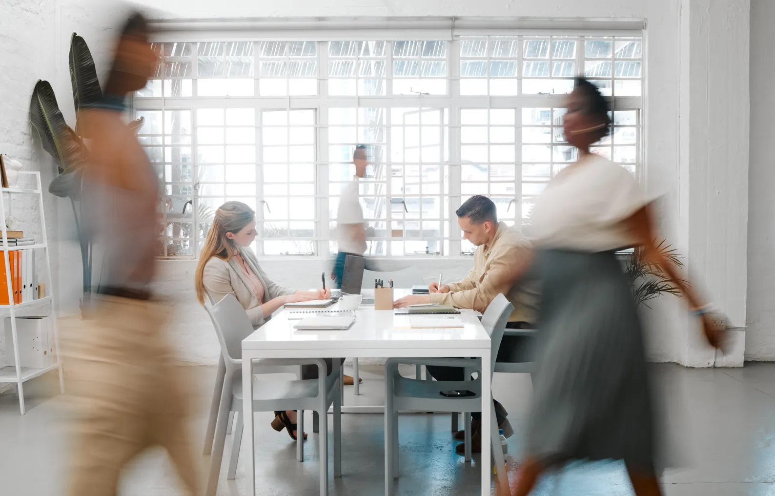 Business people walking in a creative workplace.