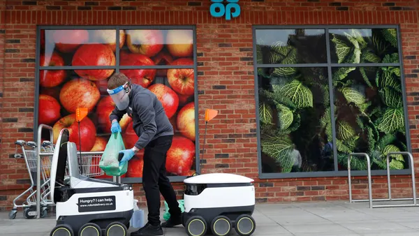 A Co-op supermarket worker loads a Starship delivery robot with groceries during a visit from the Labour Leader Keir Starmer on July 23, 2020 in Milton Keynes, England.Co-op is restoring systems in May 2025 after a major cyberattack led to major disruptions at the UK food retailer.