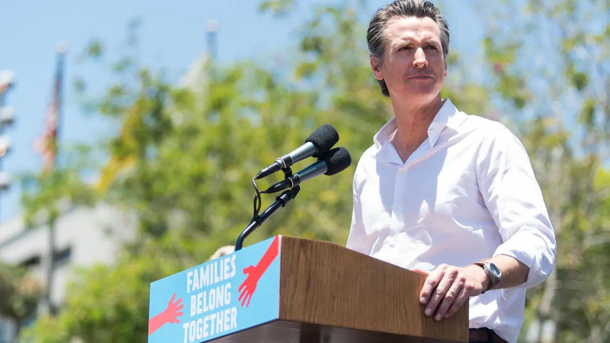 California Gov. Gavin Newsom speaks at a podium.