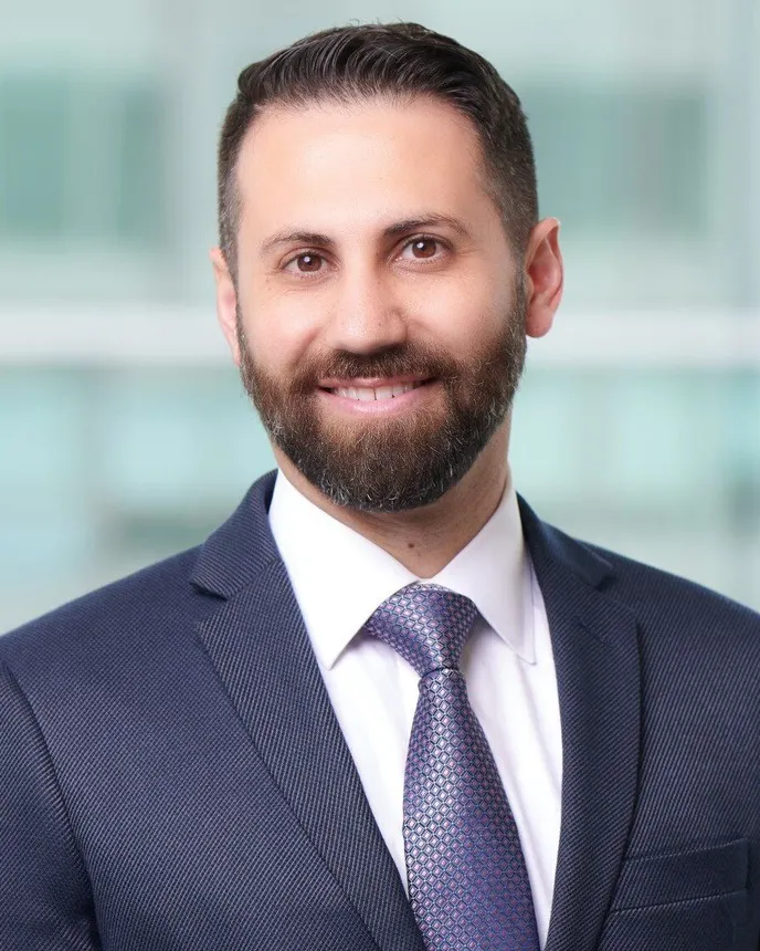 Headshot of a man in a suit.