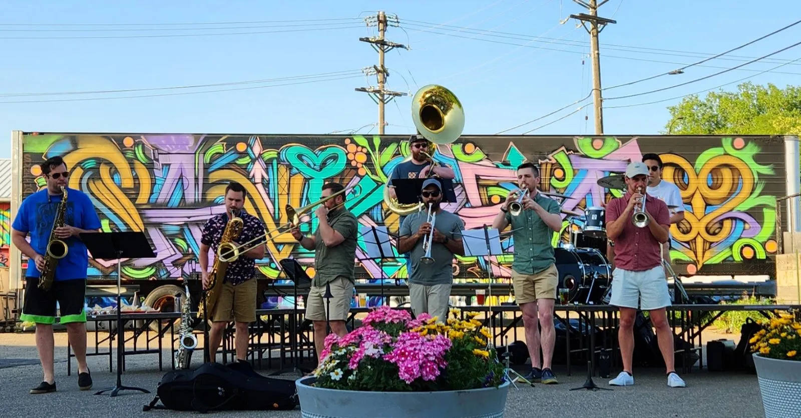 The B+Brass Band plays in front of a muraled tractor-trailer at the Urban Growler last weekend.