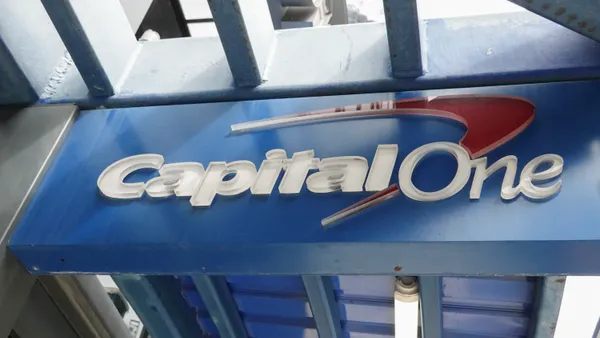 A sign hangs above an entranceway to a Capital One Café on February 19, 2024, in Miami, Florida.