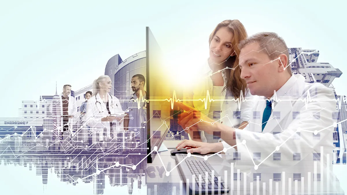 Medical professionals talking and looking at a desktop computer
