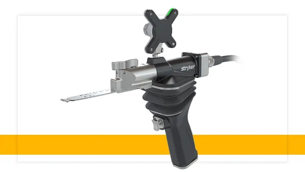 A handheld tool with a metal protrusion says "Stryker" on the side.