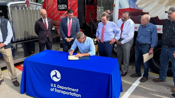U.S. Department of Transportation Secretary Sean P. Duffy signs an order announcing new English-language proficiency enforcement guidelines at a May 20 event in Austin, Texas.