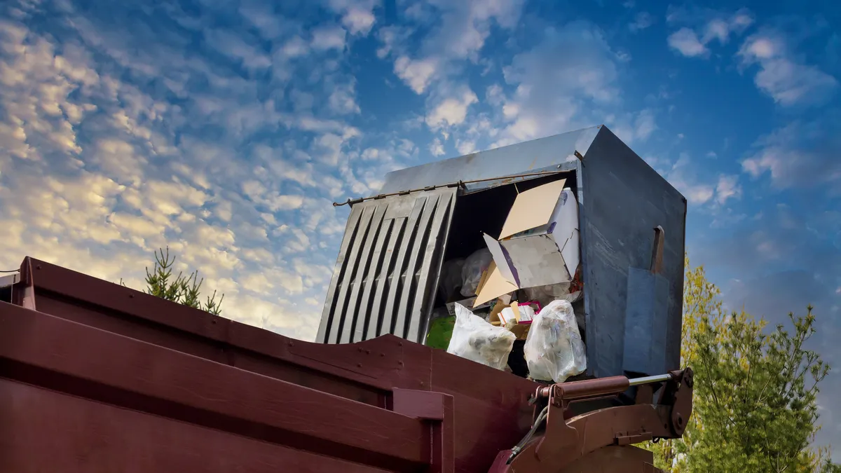 Waste container being collected