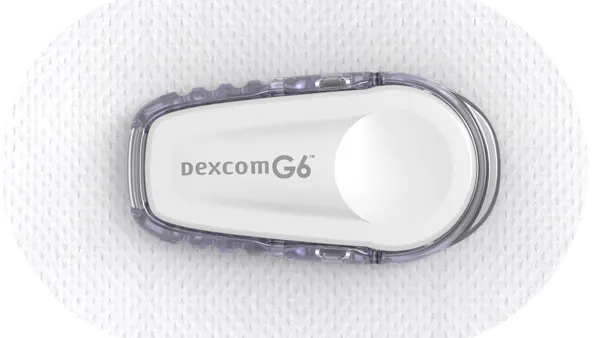 An oval shaped device on a patch says Dexcom G6.