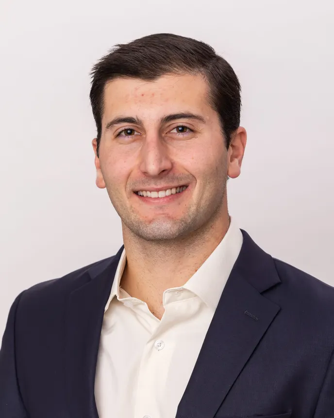 Headshot of a man in professional attire.