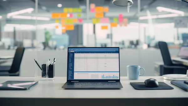 Laptop Computer with Financial Analytical Spreadsheet Application Standing on the Desk