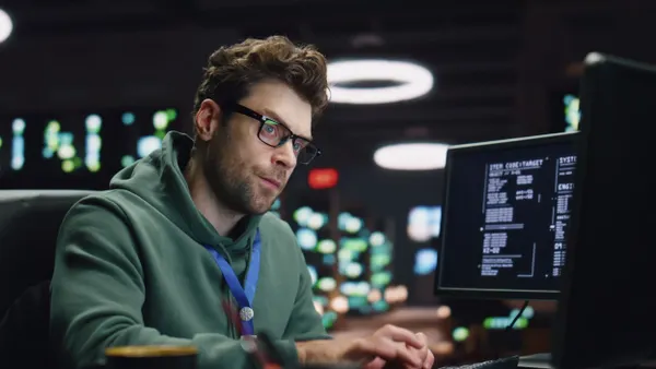 Stressed IT professional works late at night in a datacenter.
