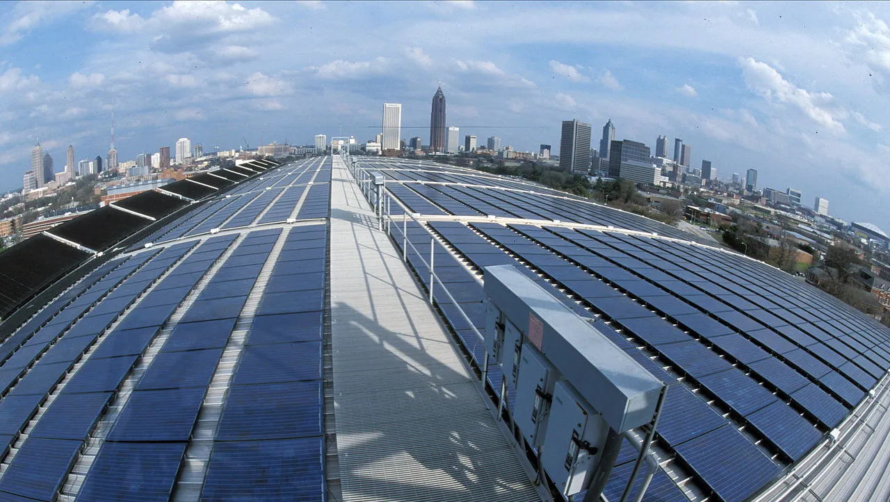 Solar panels on the Georgia Tech Aquatic Center, with Atlanta skyline in the distance