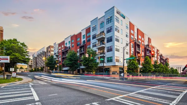 Corner view if a modern, multi-colored, mid-rise apartment building